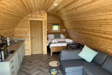 Ensuite glamping pod interior with space for a travel cot Ensuite glamping pod interior with space for a travel cot