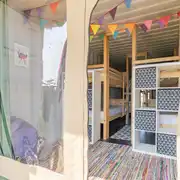 Glamping cabin interior with bunks beds and storage