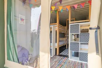 Glamping cabin interior with bunks beds and storage Glamping cabin interior with bunks beds and storage