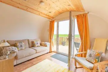 Sofa and chairs in the living room of The Bee Hive Sofa and chairs in the living room of The Bee Hive