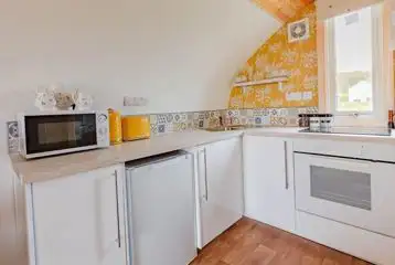 The Bee Hive kitchen with a microwave, fridge, kettle, and cutlery The Bee Hive kitchen with a microwave, fridge, kettle, and cutlery