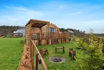 The Heron's Nest exterior with seating area and a fire pit The Heron's Nest exterior with seating area and a fire pit