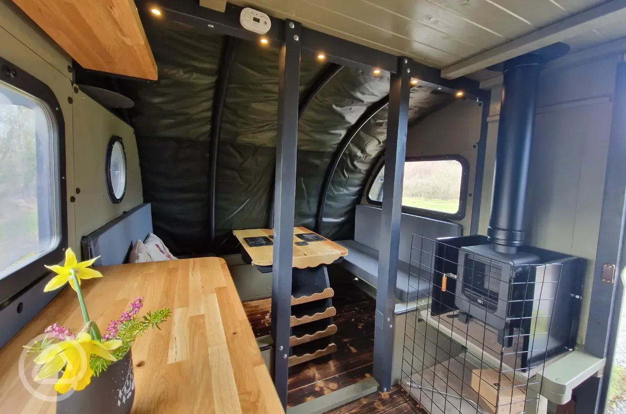 Dining area, seating, and wood-burning stove in the Foot O'Skiddaw