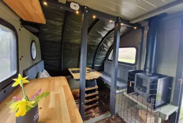 Dining area, seating, and wood-burning stove in the Foot O'Skiddaw Dining area, seating, and wood-burning stove in the Foot O'Skiddaw
