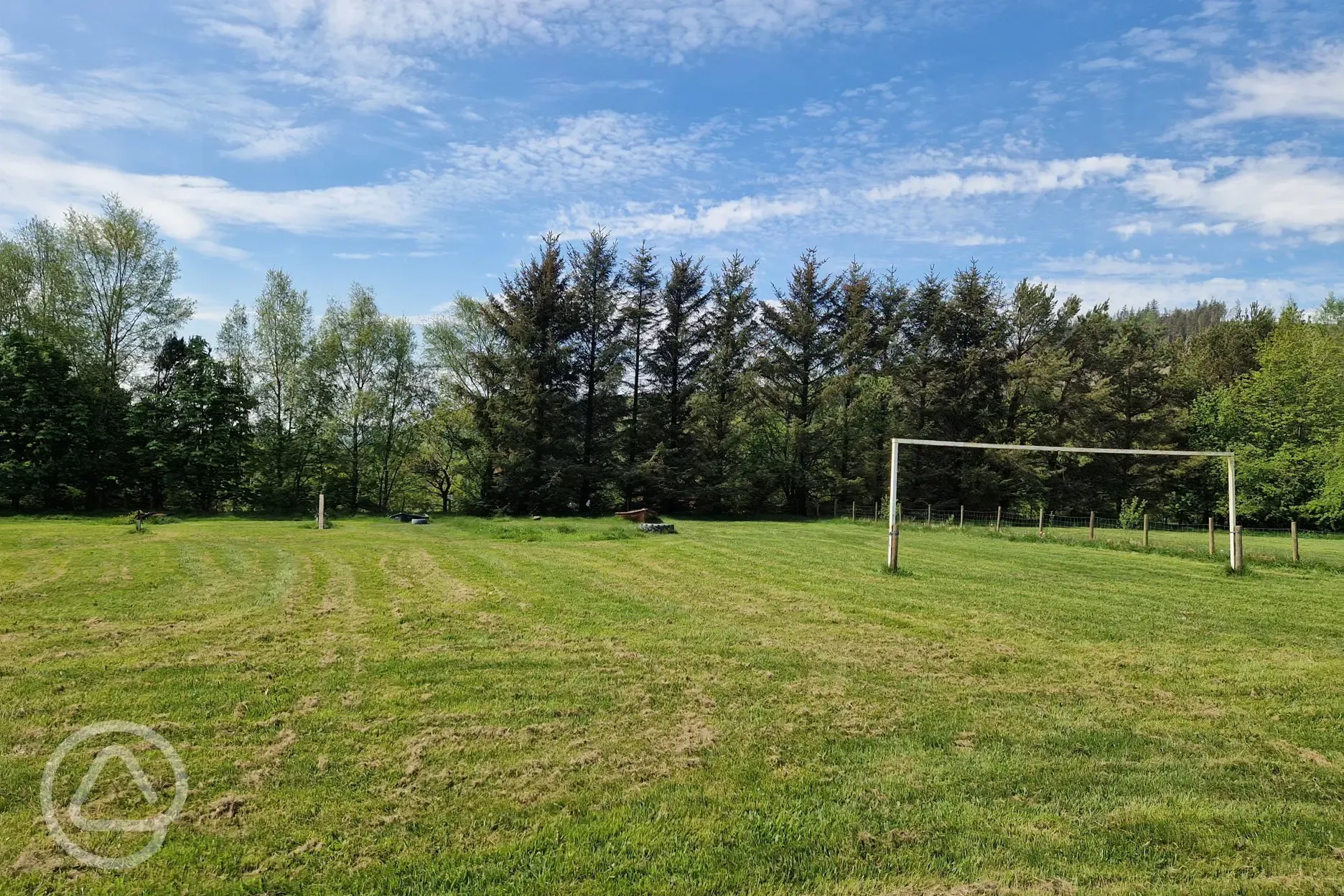 Grass area with goal posts at Kestrel Lodge Campsite