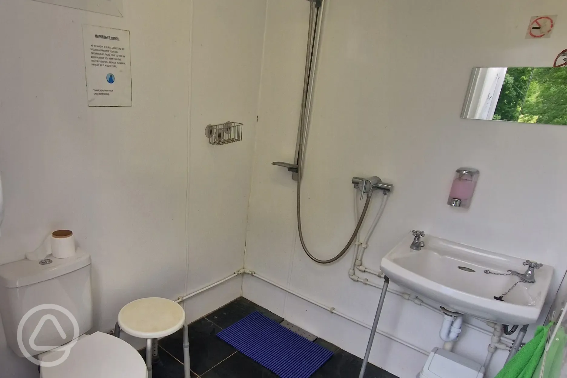 Larger communal toilet, hot shower, and sink at Kestrel Lodge