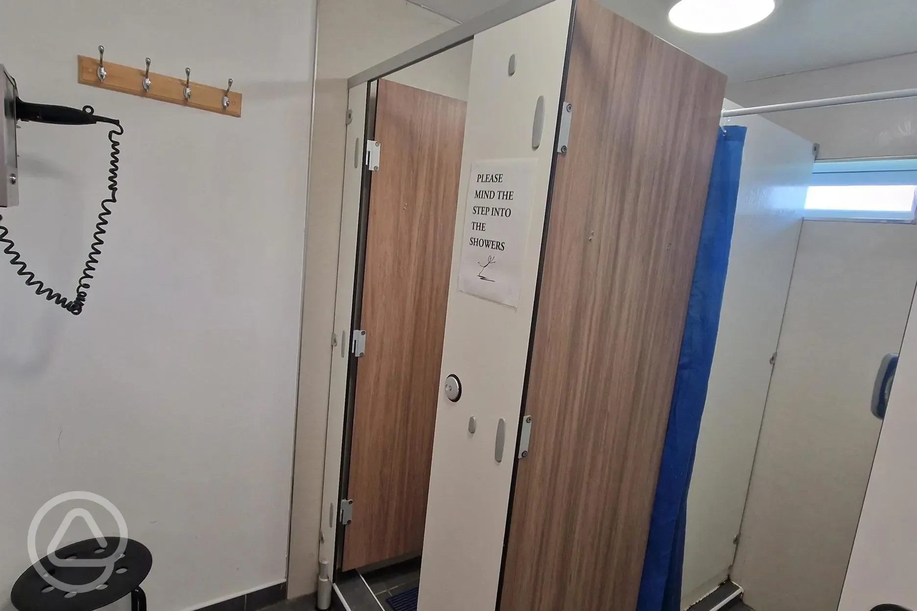 Showers with hooks and coin-operated hair dryers