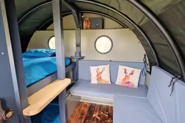 Wainwrights Den interior with a double bed and seating area (dog friendly)