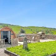 Glamping pod with hot tub and private seating area at Gillcumber Pods