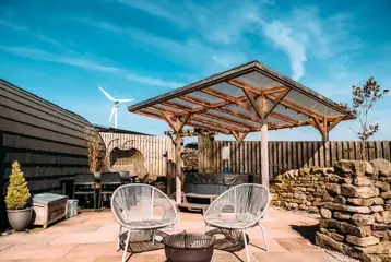 Private patios with hot tubs and cocoon swing chairs