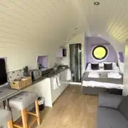 Glamping pod interior with a double bed and double sofa bed Glamping pod interior with a double bed and double sofa bed