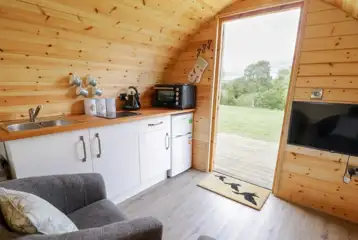 Embden glamping pod interior with a dining area and smart TV Embden glamping pod interior with a dining area and smart TV