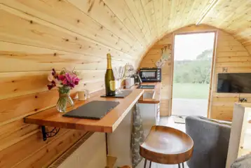 Embden glamping pod interior with a dining area and smart TV Embden glamping pod interior with a dining area and smart TV