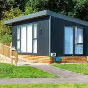 Deluxe ensuite glamping pods with and outdoor deck, table, chairs and brick BBQ