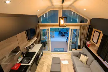 Superior glamping cabin with a double sofa bed and equipped kitchen