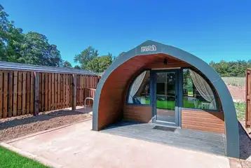 Glamping pod with a patio area and glass front