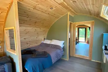 Glamping pod interior with a double bed (bedding and towels provided)