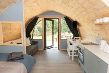 View from the double bed with a double sofa bed, dining area and kitchenette