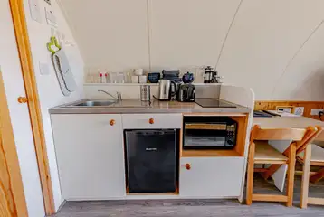 Kitchen with a sink, kettle, toaster, fridge, freezer, hob and combi oven