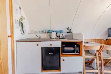 Kitchen with a sink, kettle, toaster, fridge, freezer, hob and combi oven