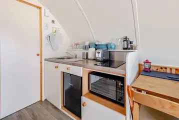 Kitchen with a sink, kettle, toaster, fridge, freezer, hob and combi oven
