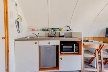 Kitchen with a sink, kettle, toaster, fridge, freezer, hob and combi oven
