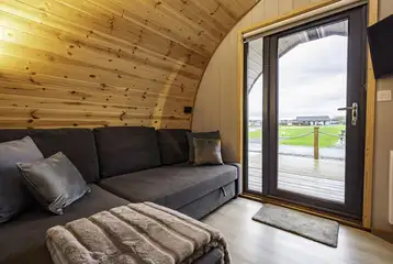 Mega glamping pod interior with a double sofa bed